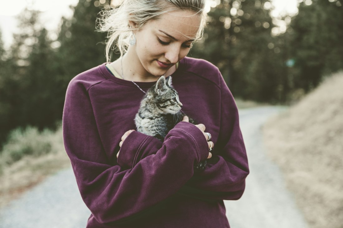 Woman hugging a kitten